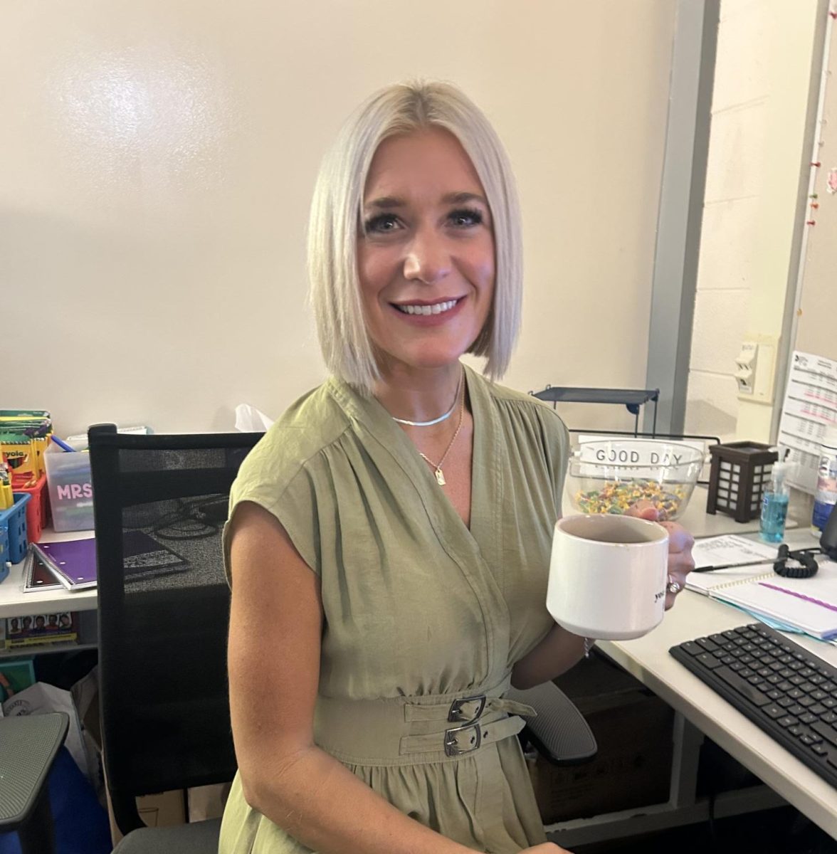 Ms. Martin at her desk drinking her hot tea.