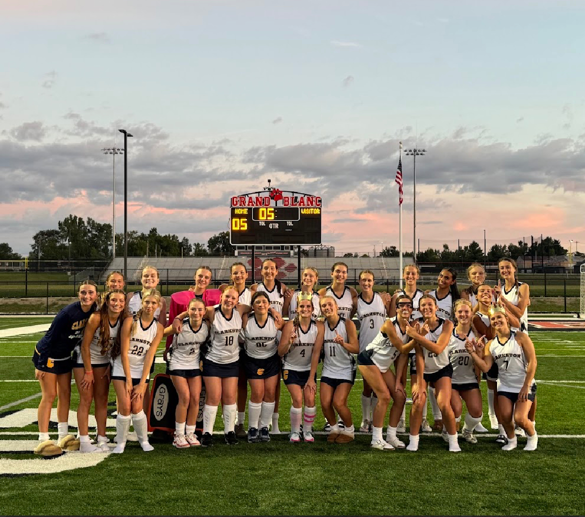 The team celebrates their win against Grand Blanc. Photographer: Logan Brown