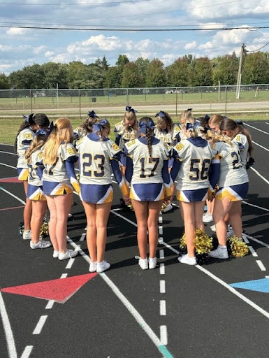 The CHS Freshman Cheer team stand in a huddle.