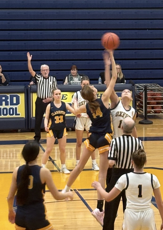 Abby Beddick reaching for the basketball.
